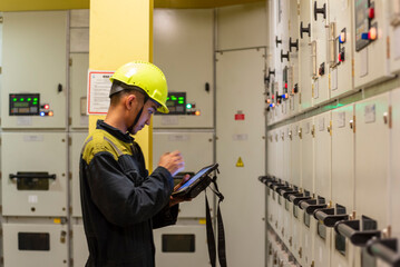 Portrait of young marine engineer, Filipino seafarer, during his daily routine work in engine room....