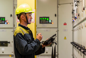 Portrait of young marine engineer, Filipino seafarer, during his daily routine work in engine room. Seafarers life.