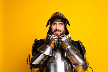 Cheerful Man in a Shining Knight Armor on a Bright Yellow Background