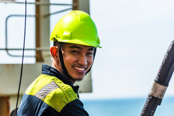 Portrait of the young Filipino officer, fully focused on his task during the inspection of the...