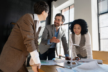 Engineers analyzing blueprints and discussing renewable energy project