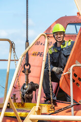 Portrait of the young Filipino officer, fully focused on his task during the inspection of the...