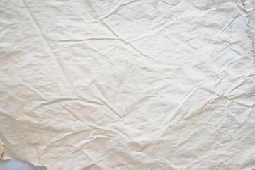 Abstract grunge crumpled paper texture background. Off-white, aged paper background with stains