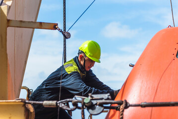 Portrait of the young Filipino officer, fully focused on his task during the inspection of the...