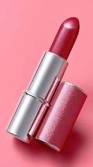 Obraz premium Elegant Rose Red Lipstick on Pink Background Displaying Glamour