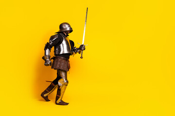Medieval Knight in Shining Armor with Sword on Bright Yellow Background