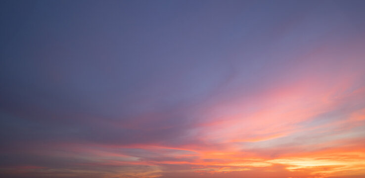 Sunset sky. Abstract nature background. Dramatic blue with orange colorful clouds in twilight time.
