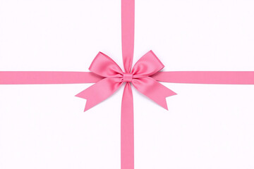 pink ribbon tied in a bow on a white background