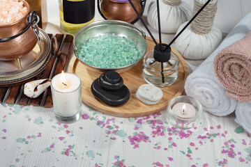 Spa items are arranged in a composition on a table.