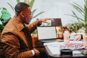 Focused individuals engaged in business strategy discussion, reviewing analytics on a laptop in a...