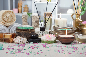 Spa items are arranged in a composition on a table.