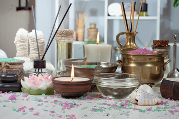 Spa items are arranged in a composition on a table.