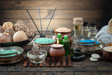 Spa treatment with candles and towel on wooden table, closeup