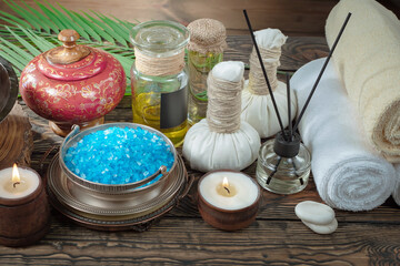 Spa items are arranged in a composition on a table.