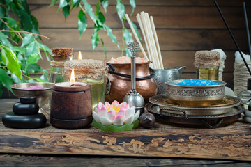Spa treatment with candles and towel on wooden table, closeup