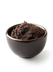 Dark brown paste in a small bowl isolated on a white background.