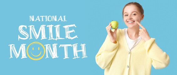 Happy young woman with apple pointing at her teeth on light blue background. Banner for National Smile Month