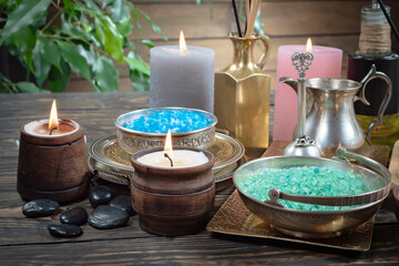 Spa treatment with candles and towel on wooden table, closeup