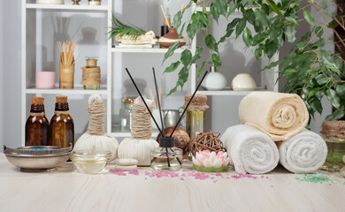 Spa treatment with candles and towel on wooden table, closeup