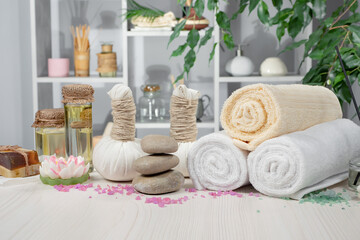 Spa items are arranged in a composition on a table.