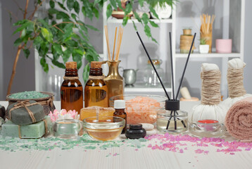 Spa items are arranged in a composition on a table.