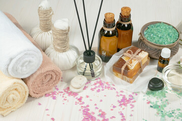 Spa items are arranged in a composition on a table.
