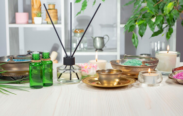 Spa treatment with candles and towel on wooden table, closeup