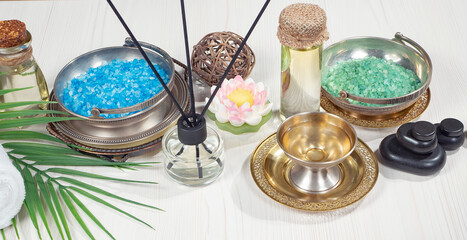 Spa items are arranged in a composition on a table.