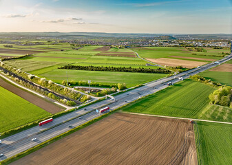 German highway A 81 and highspeed railway track crossing the fertile agricultural landscape of Langes Feld north of Stuttgart, Baden-Wuerttemberg, Germany
