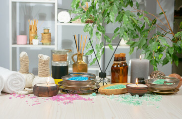 Spa items are arranged in a composition on a table.
