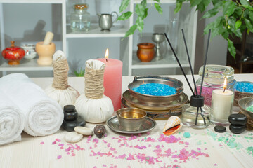 Spa items are arranged in a composition on a table.