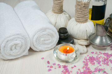 Spa items are arranged in a composition on a table.