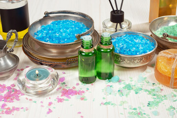 Spa items are arranged in a composition on a table.