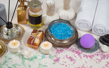Spa items are arranged in a composition on a table.