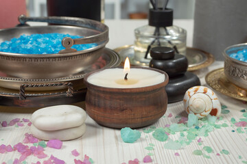 Spa treatment with candles and towel on wooden table, closeup
