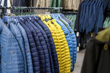 Colorful collection of jackets displayed in a clothing store showcasing various styles and fabrics...