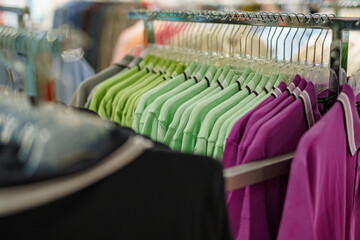 Display of brightly colored polo shirts in a retail store during daytime