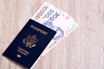 Fototapeta premium American passport with Ukrainian money