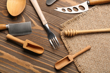 Different kitchen utensils on wooden background