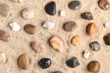 Many pebble stones on sand