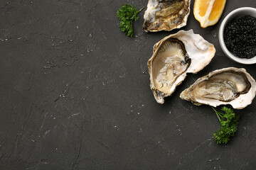 Tasty oysters with lemon and caviar on black background