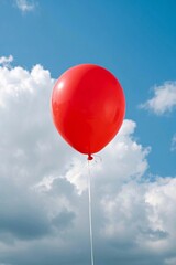 Obraz premium there is a red balloon floating in the air with a blue sky behind it