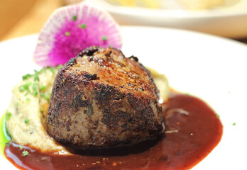 Medium rare beef steak with mashed potatoes