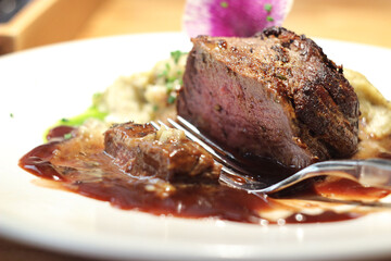Medium rare beef steak with mashed potatoes