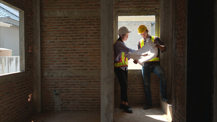 Architects and engineers work together to assess the residential home construction site's progress