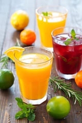 Vibrant, Refreshing Summer Drinks with Fresh Fruits, Herbs, and Wooden Table Setting, Perfect for Outdoor Gatherings and Entertaining Guests