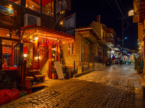 Streets and taverns with traditional Greek cuisine illuminated in the evening in the tourist village of Metsovo in the mountains of Epirus in Greece