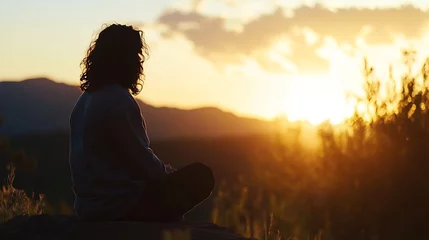 Papier peint photo Coucher de soleil Peaceful silhouette of a person meditating at sunset in serene mountain landscape : Generative AI  © Generative AI