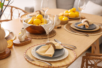 Stylish table setting decorated with many fresh lemons in dining room