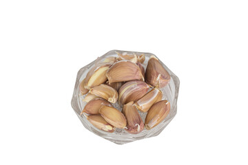 garlic cloves in a glass bowl isolated on white background